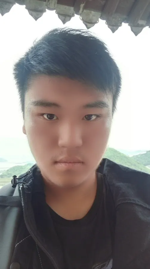 户外屋檐下的自拍:一名背着双肩包的男生看向镜头